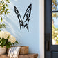 Black butterfly wall vinyl decal on light wall near window