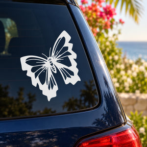 White butterfly vinyl car decal on the rear window of a dark car