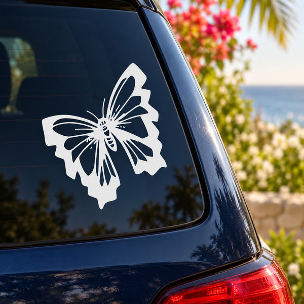 White butterfly vinyl car decal on the rear window of a dark car
