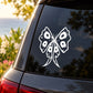 White butterfly vinyl decal on a car rear window, outlined in black details.