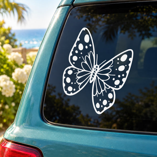 Butterfly vinyl decal in white with dotted wing pattern on car window