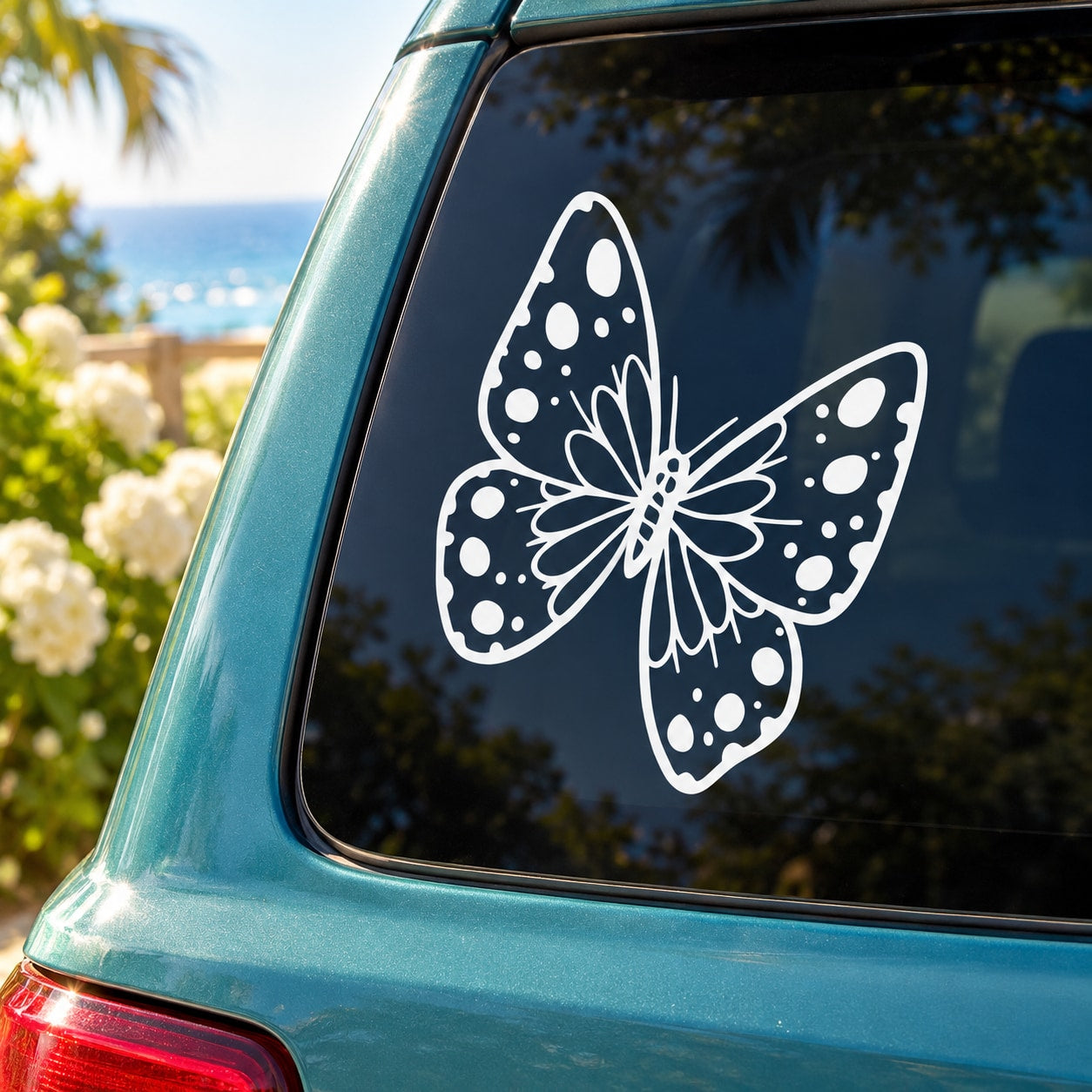 Butterfly vinyl decal in white with dotted wing pattern on car window