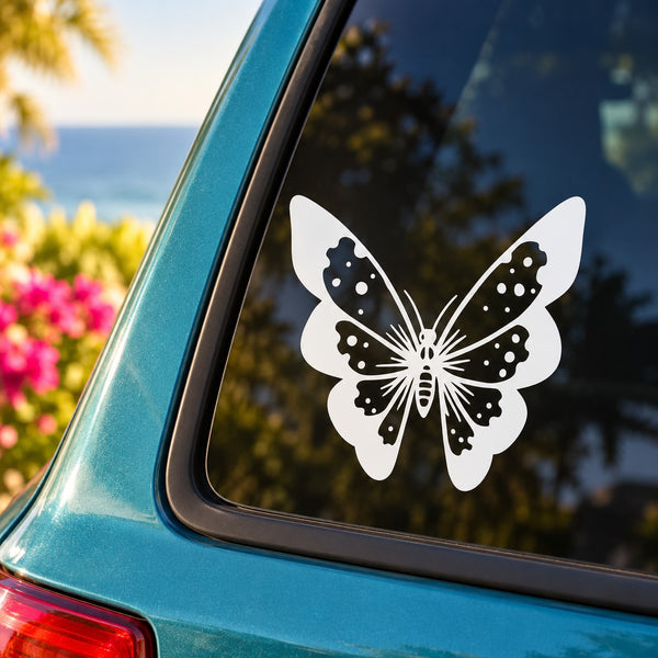 Butterfly vinyl decal with white wings and black dot pattern on car window