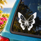 Butterfly vinyl decal with white wings and black dot pattern on car window