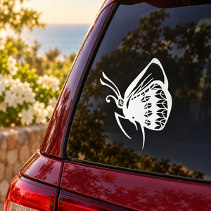 White butterfly vinyl decal on car side window, bold linework and open wings.