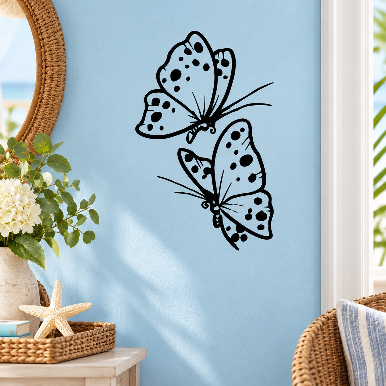 Butterfly wall decal with two dotted butterflies in black outline and light blue fill