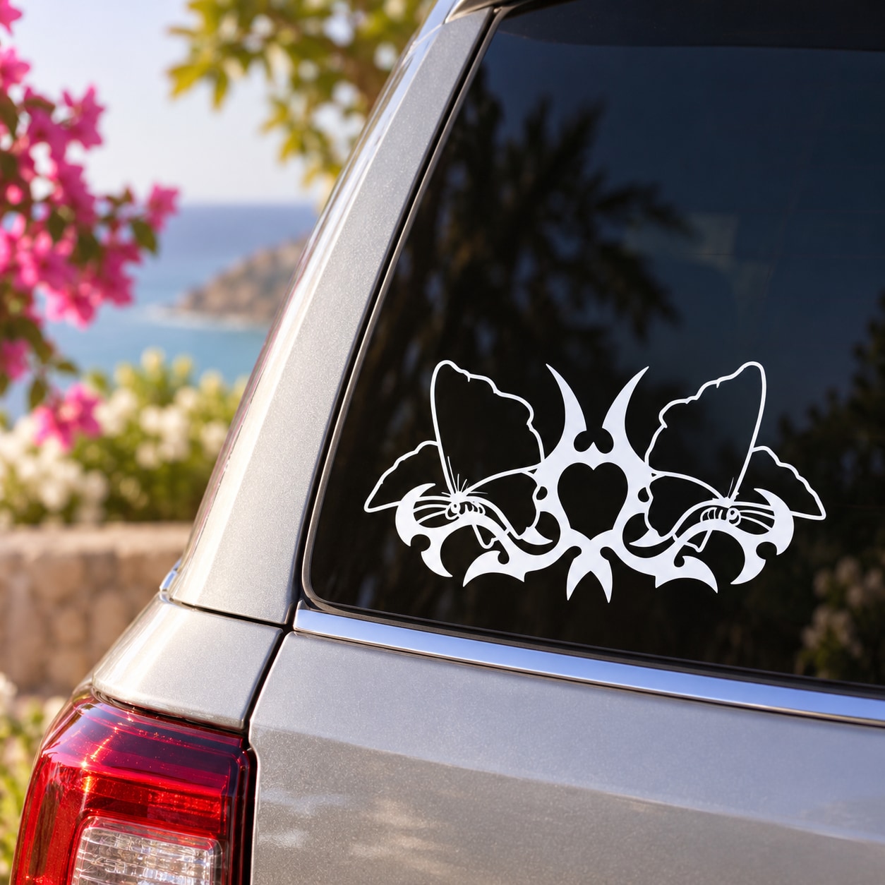 Butterfly vinyl decal with three white outlined butterflies on a car window