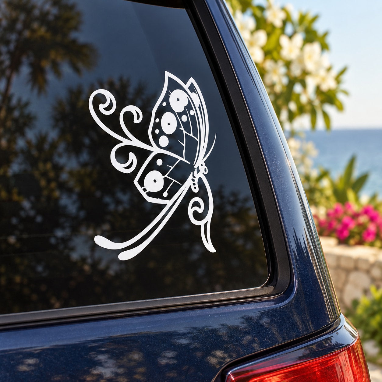 White butterfly vinyl decal on car window, swirled wings and antennae
