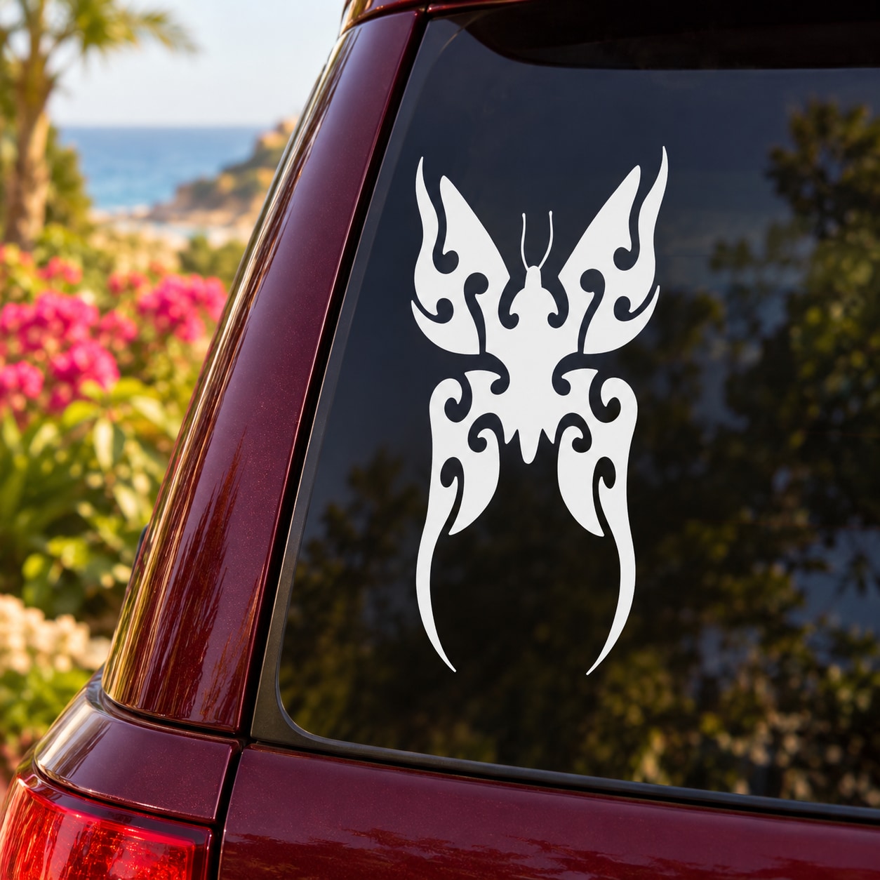 White butterfly vinyl decal with ornate symmetrical wings on dark car window