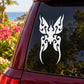 White butterfly vinyl decal with ornate symmetrical wings on dark car window