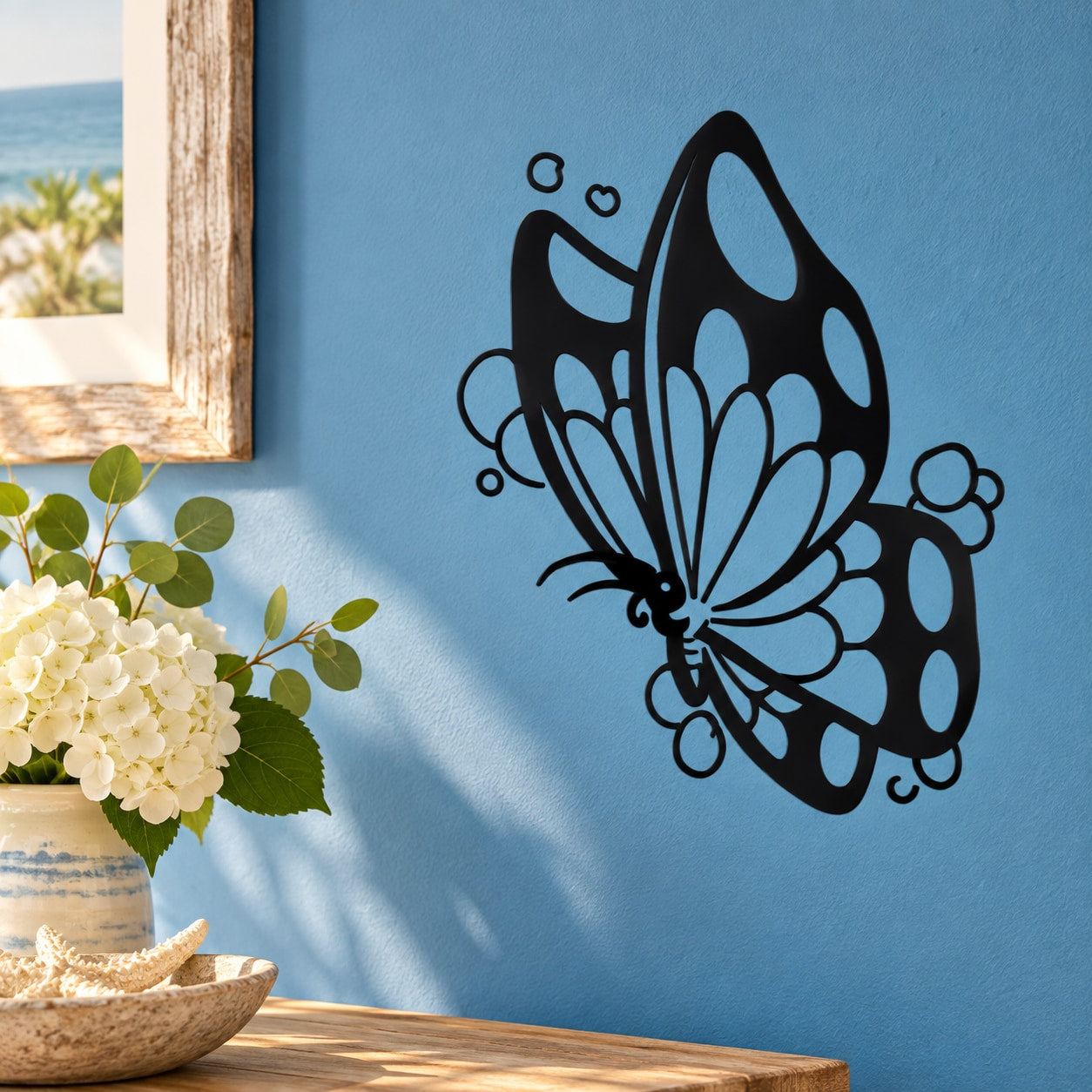 Black butterfly vinyl wall decal with white patterned wings and curling accents