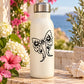 Butterfly vinyl decal sticker with black line-art wings on a light bottle