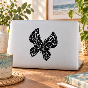 Black butterfly vinyl decal with detailed wings, applied on a light surface