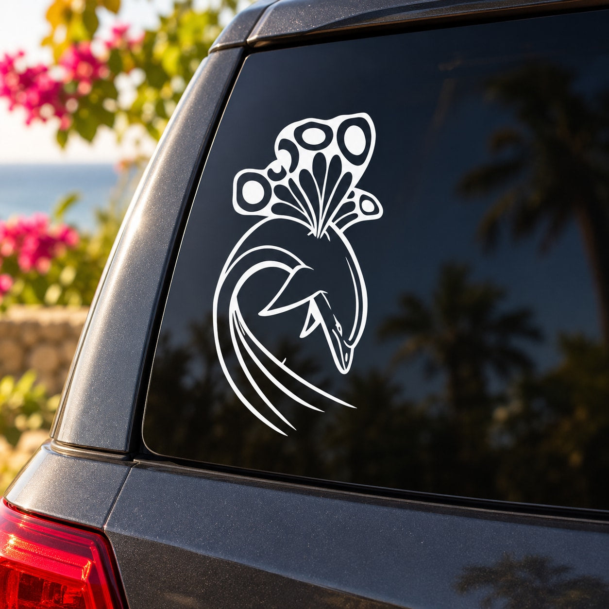 White butterfly vinyl decal with detailed wings and curled tail on dark car window