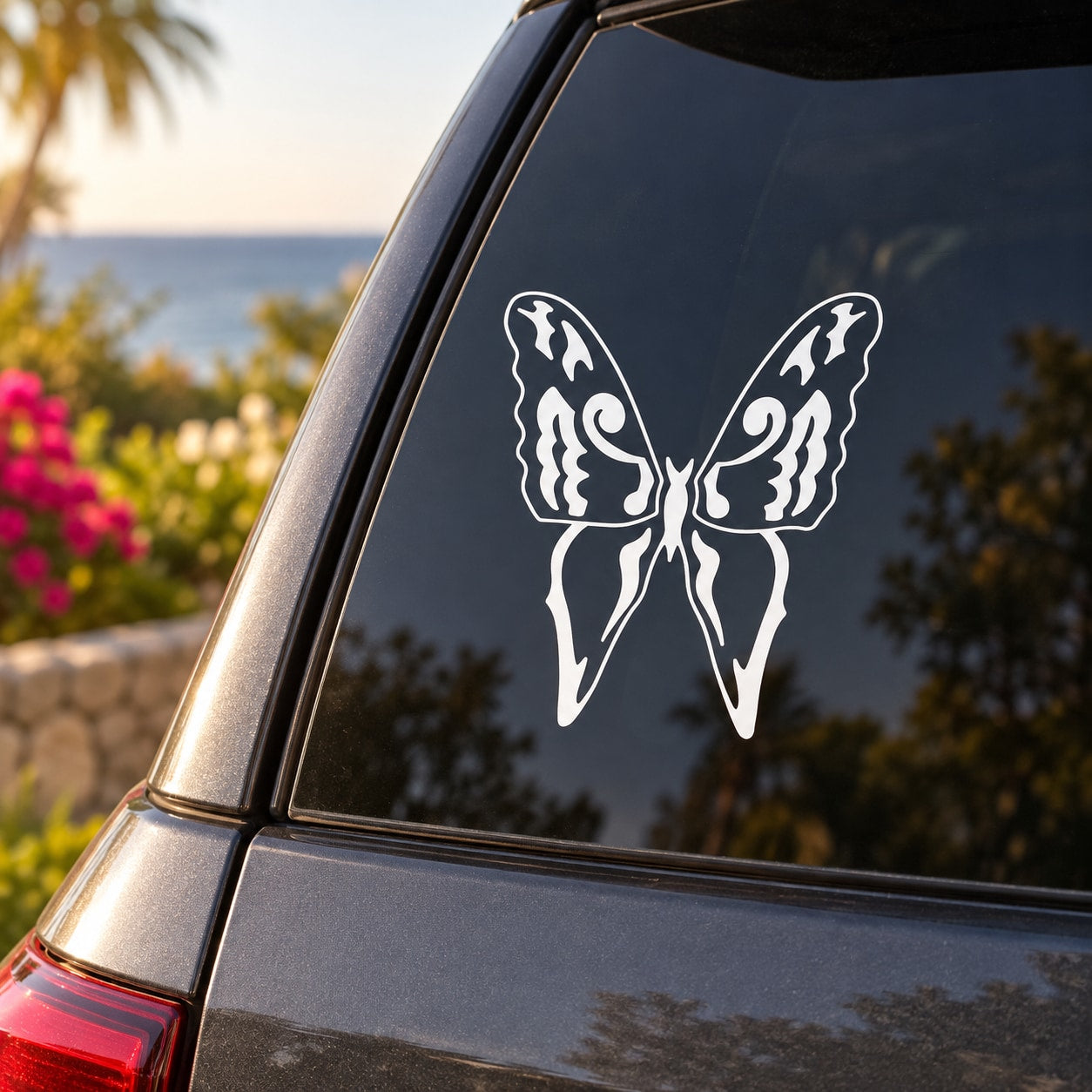 Butterfly vinyl decal with white outline on a dark car window