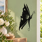 Black landing butterfly wall decal with decorative swirls and wing accents