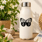 Black post-modern butterfly decal with curled wing details on a white bottle