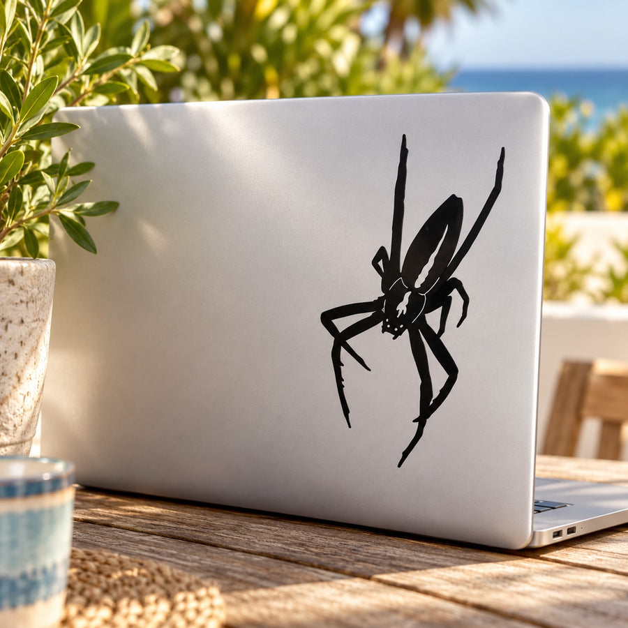 Black crawling spider beetle decal on a laptop lid