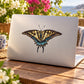Butterfly flying decal with blue, yellow and black wings on a light laptop lid