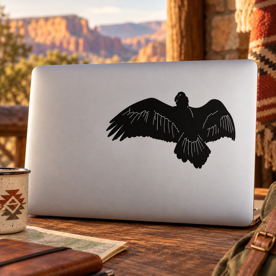 Vulture flapping black decal on silver laptop lid