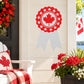 Red rosette circle sticker with white maple leaf center and scalloped border