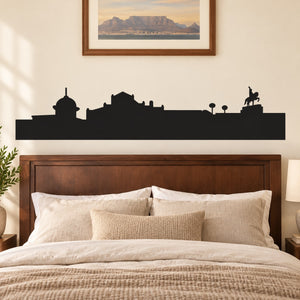 Black skyline vinyl wall decal with buildings, streetlamps, and seated silhouette figure