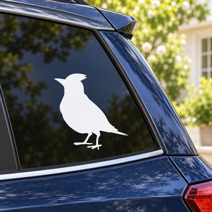 White bird silhouette decal on car window panel