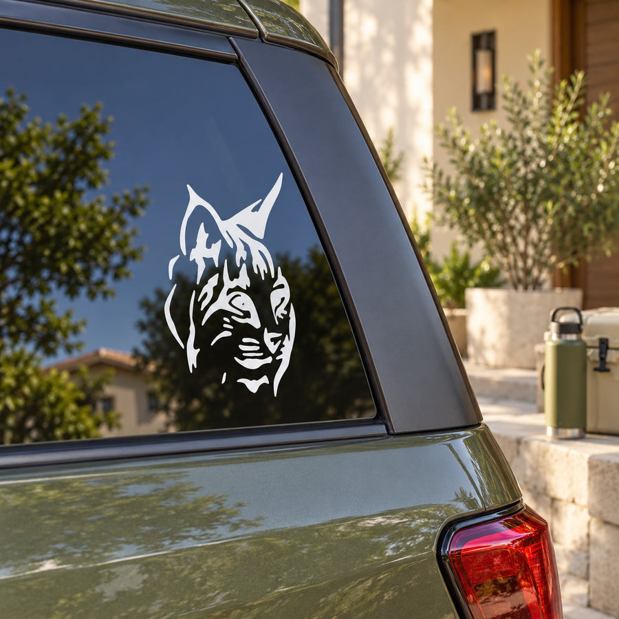 Bobcat head decal, white stylized bobcat face on car window glass
