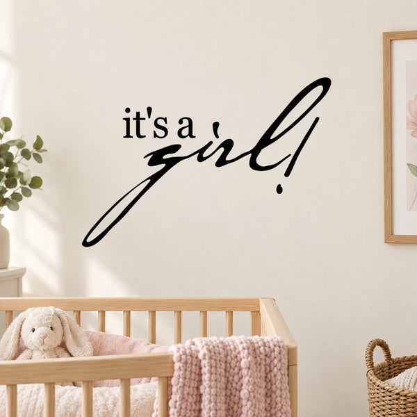Baby shower wall decal with black "it's a girl" lettering