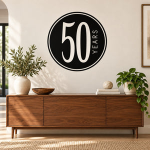 Black circular decal with large white “50” and vertical “YEARS” lettering.
