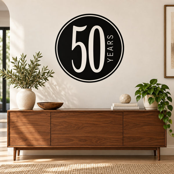 Black circular decal with large white “50” and vertical “YEARS” lettering.