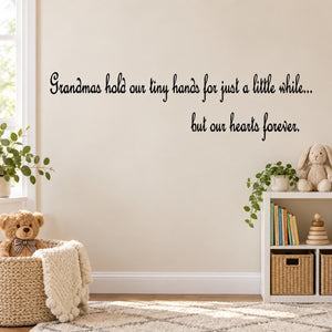 Wall decal with cursive quote: Grandmas hold our tiny hands, hearts forever.