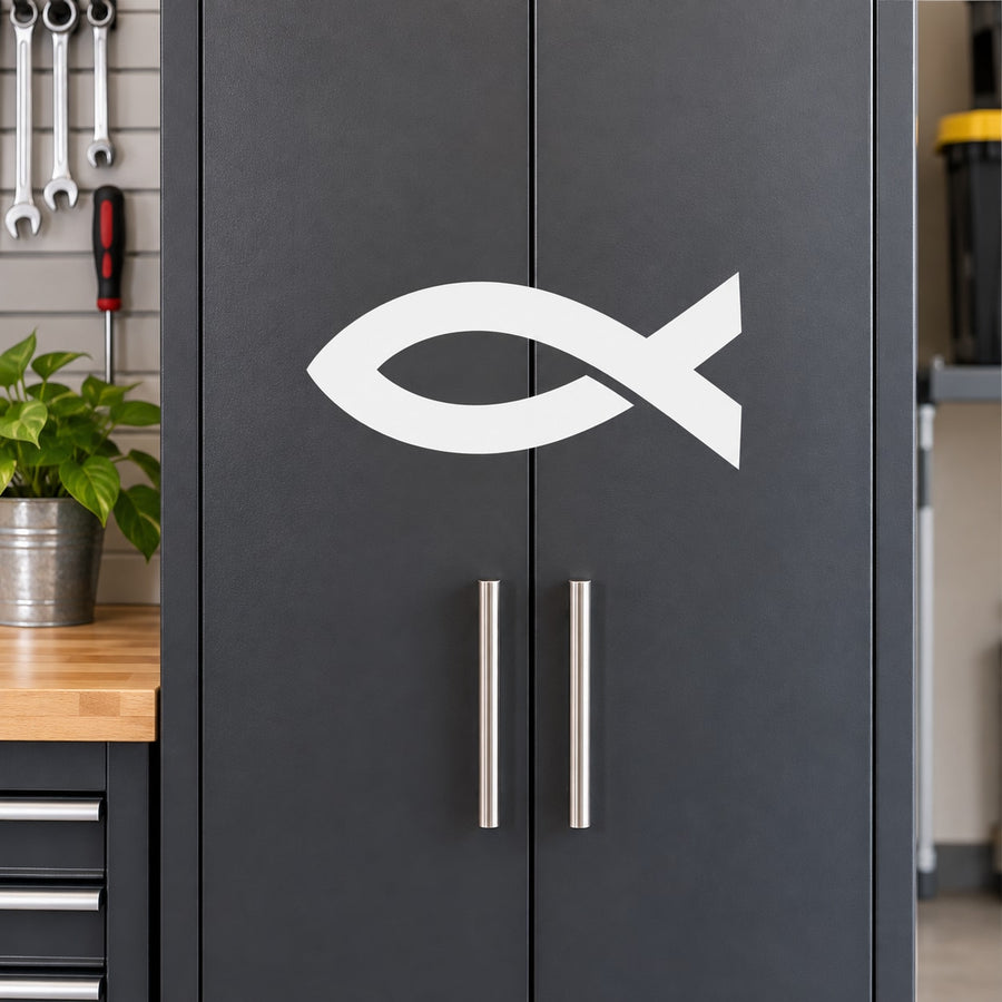 White Christian fish decal on dark cabinet door