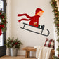 Boy sledding printed die-cut decal with red-clad child on a white sled