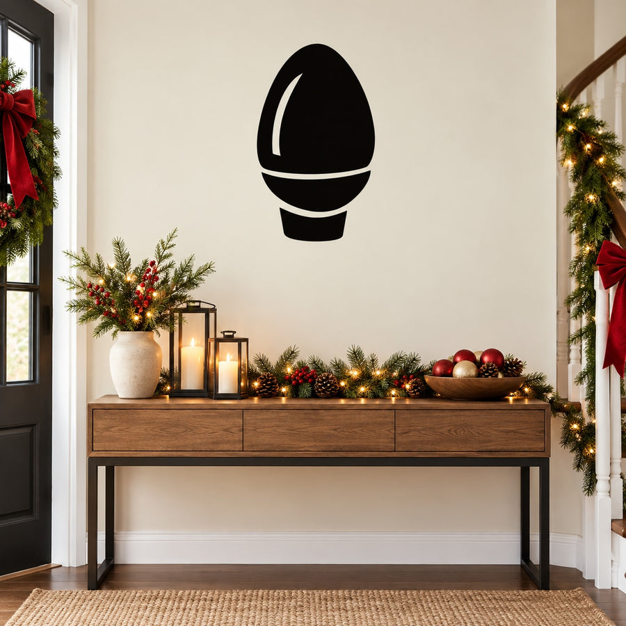 Bulb-shaped Christmas light decal in black outline on a wall