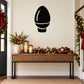 Bulb-shaped Christmas light decal in black outline on a wall