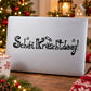 Black stylized Christmas text decal on white backing, with stars and flourishes