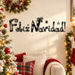 Black wall decal with Feliz Navidad lettering, stars, and gift icons
