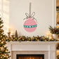 Pink Christmas ornament decal with teal striped design, bow, and hanging loop