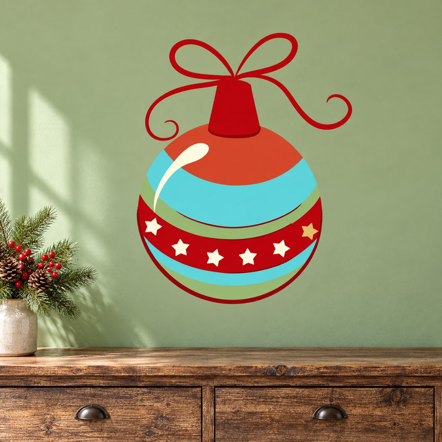 Round Christmas ornament vinyl decal with red ribbon bow, teal and orange stripes, star accents