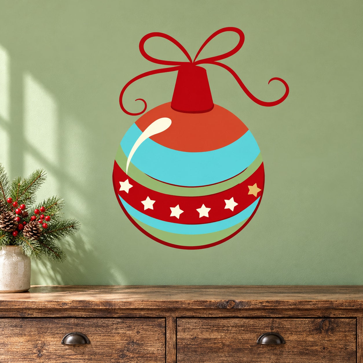 Round Christmas ornament vinyl decal with red ribbon bow, teal and orange stripes, star accents