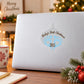 White ornament sticker with baby feet print, “Baby's First Christmas” and year 2015