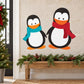 Two penguin die-cut decals with red and teal scarves