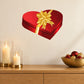 Heart-shaped gift sticker with red present box and gold bow
