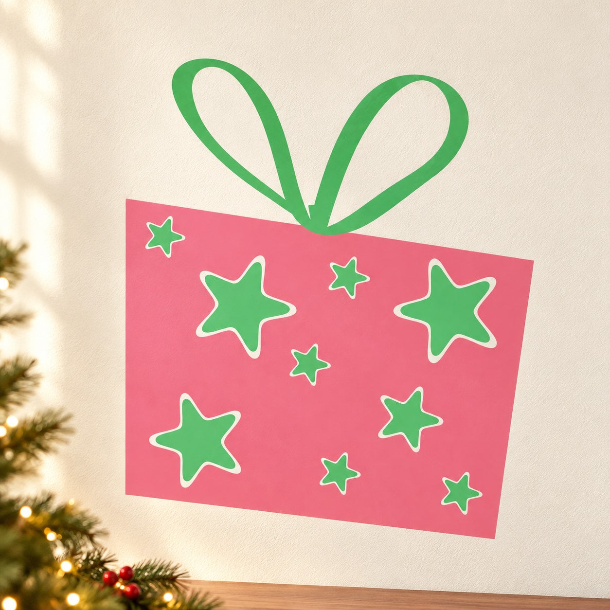 Pink rectangular gift with green ribbon and small star stickers