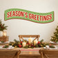 Season's Greetings banner sticker, green curved banner with red border and white text