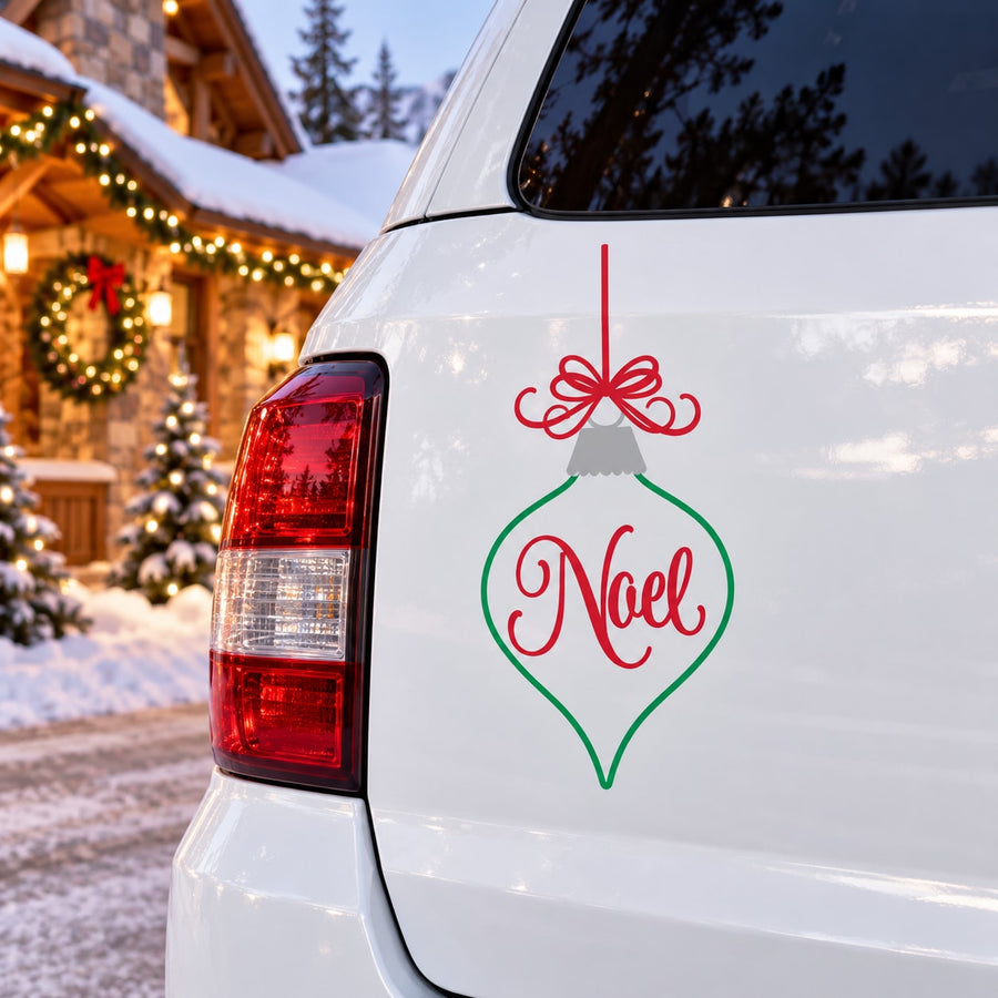 Christmas Noel ornament decal with red bow and green outline on white surface