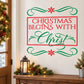 Christmas Begins with Christ wall decal with red frame, green scrolls, and snowflakes