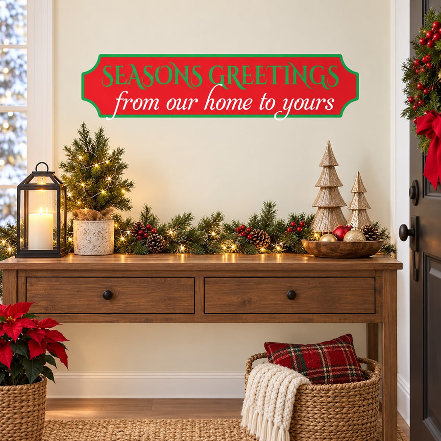 Holiday greeting sticker with ribbon banner text 'SEASONS GREETINGS from our home to yours'