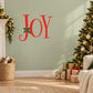 Red JOY wall decal with bow accents on the O